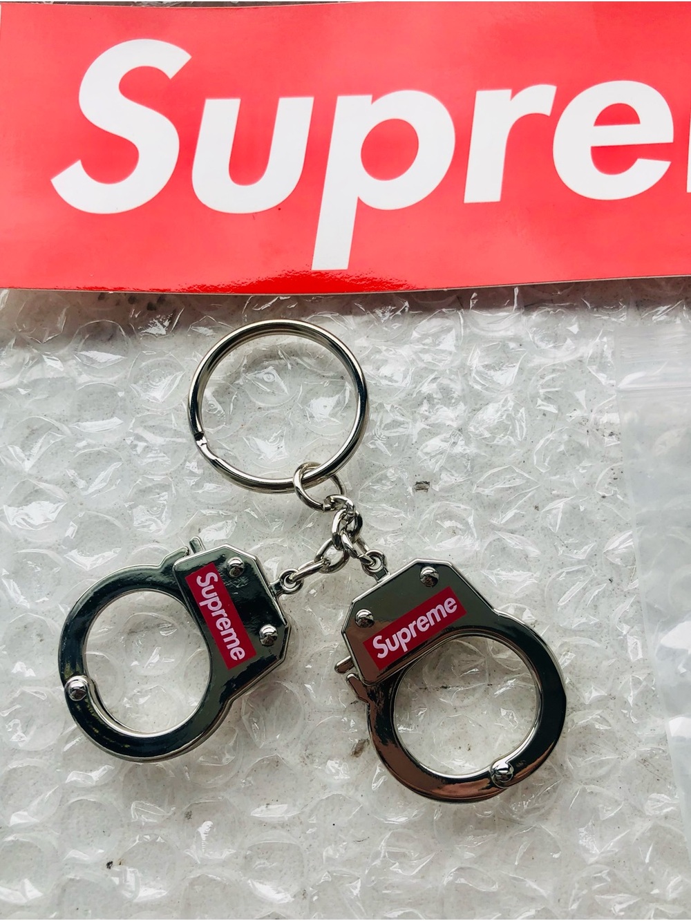 Supreme Silver Handcuff Keyring with Red Logo